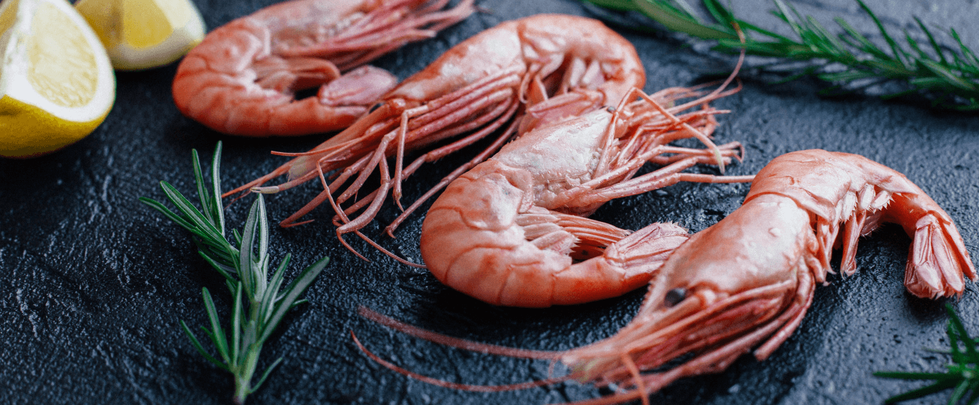 prawns with rosemary & lemon on rustic black background